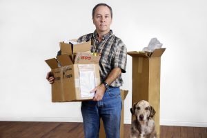 Divorced man moving out of house with dog
